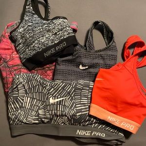 5 Nike sports bras. 3 padded size small and 2 non padded size medium.